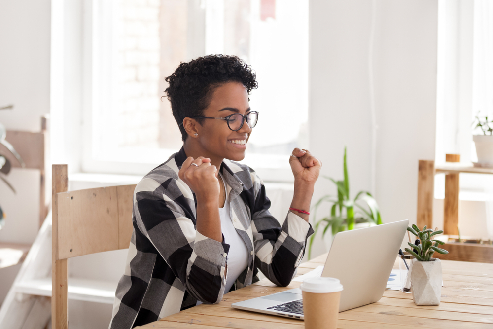 Approved Mortgage - a woman excited about something on her computer